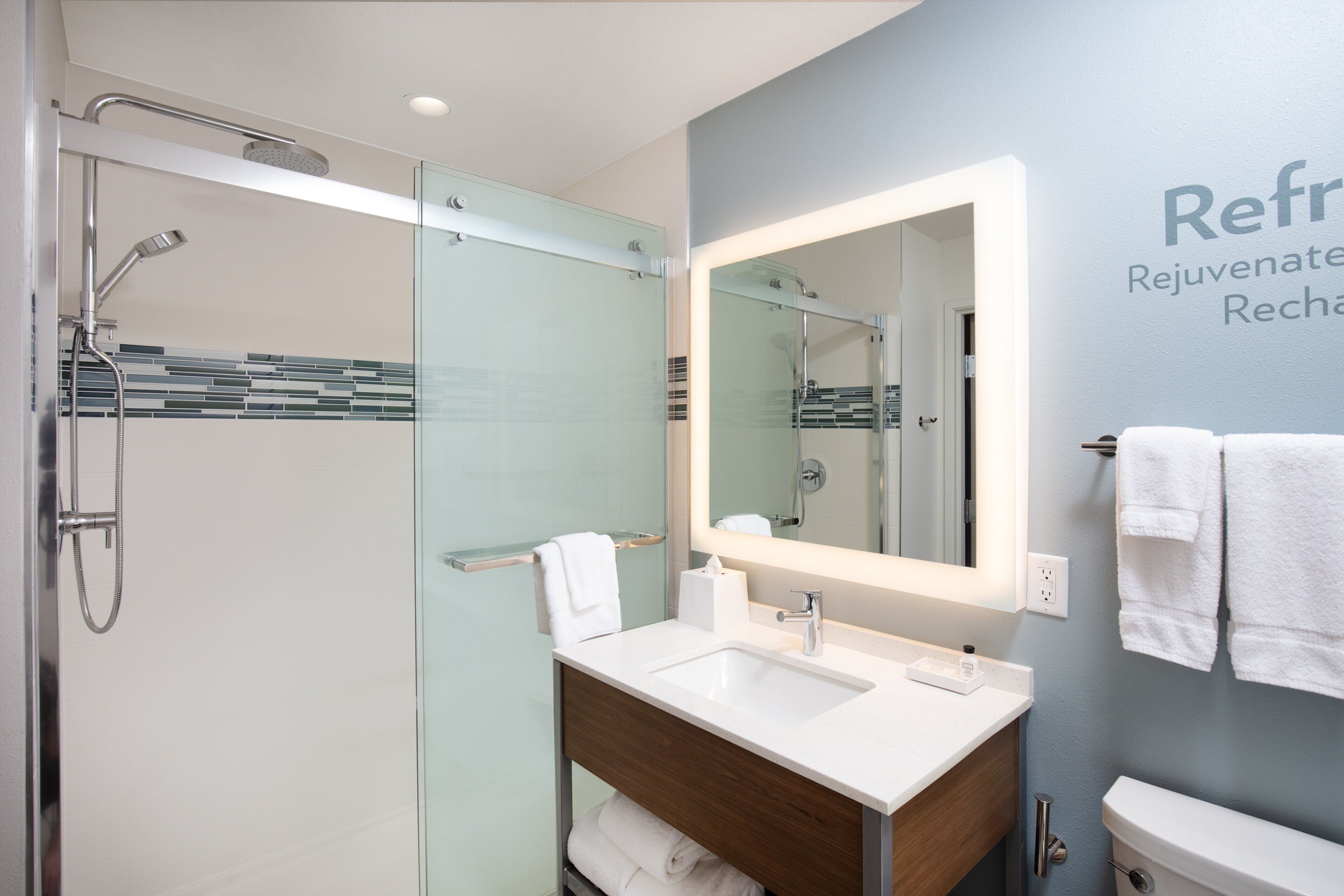 designer toiletries, hair dryer, towels