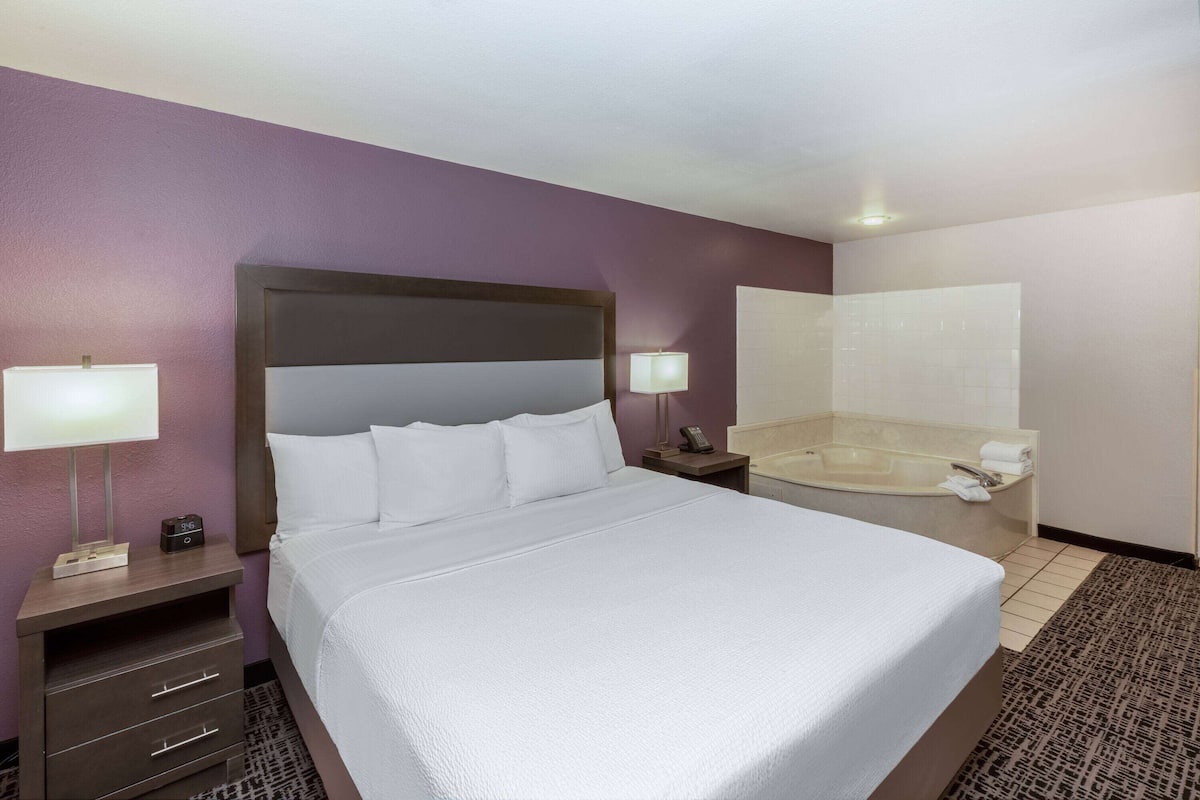 Premium bedding, desk, laptop workspace, iron/ironing board