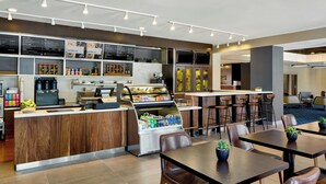 A modern bistro bar with a counter, seating area, and a refrigerated display case. - Courtyard by Marriott Providence Downtown (Providence)