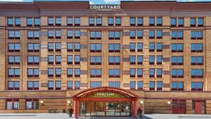 A multi-story hotel with a prominent 'Courtyard by Marriott' sign, large windows, and a central entrance. - Courtyard by Marriott Providence Downtown (Providence)