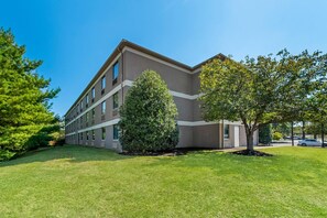 A modern building with a flat roof, large windows, and a well-maintained lawn with two trees. - Quality Inn Shepherdstown (Shepherdstown)