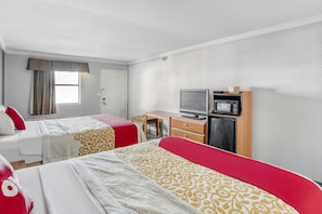 A hotel room with two beds, a desk, a television, and a microwave. - Hotel Pineville LA Hwy 165 (Pineville)