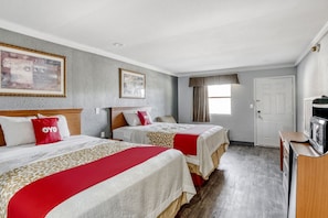 A hotel room with two beds, a TV, and a door. - Hotel Pineville LA Hwy 165 (Pineville)