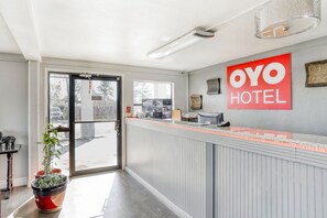 A hotel reception area with a glass door entrance, a reception desk, and a sign reading 'OYO HOTEL'. - Hotel Pineville LA Hwy 165 (Pineville)