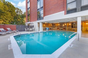 A swimming pool with lounge chairs and a covered seating area. - Drury Inn & Suites Birmingham Grandview (Birmingham)