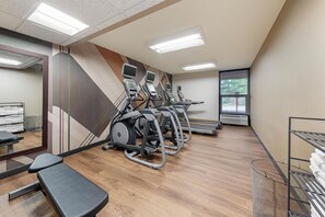 A gym with treadmills, elliptical machines, and a bench. - Drury Inn & Suites Birmingham Grandview (Birmingham)