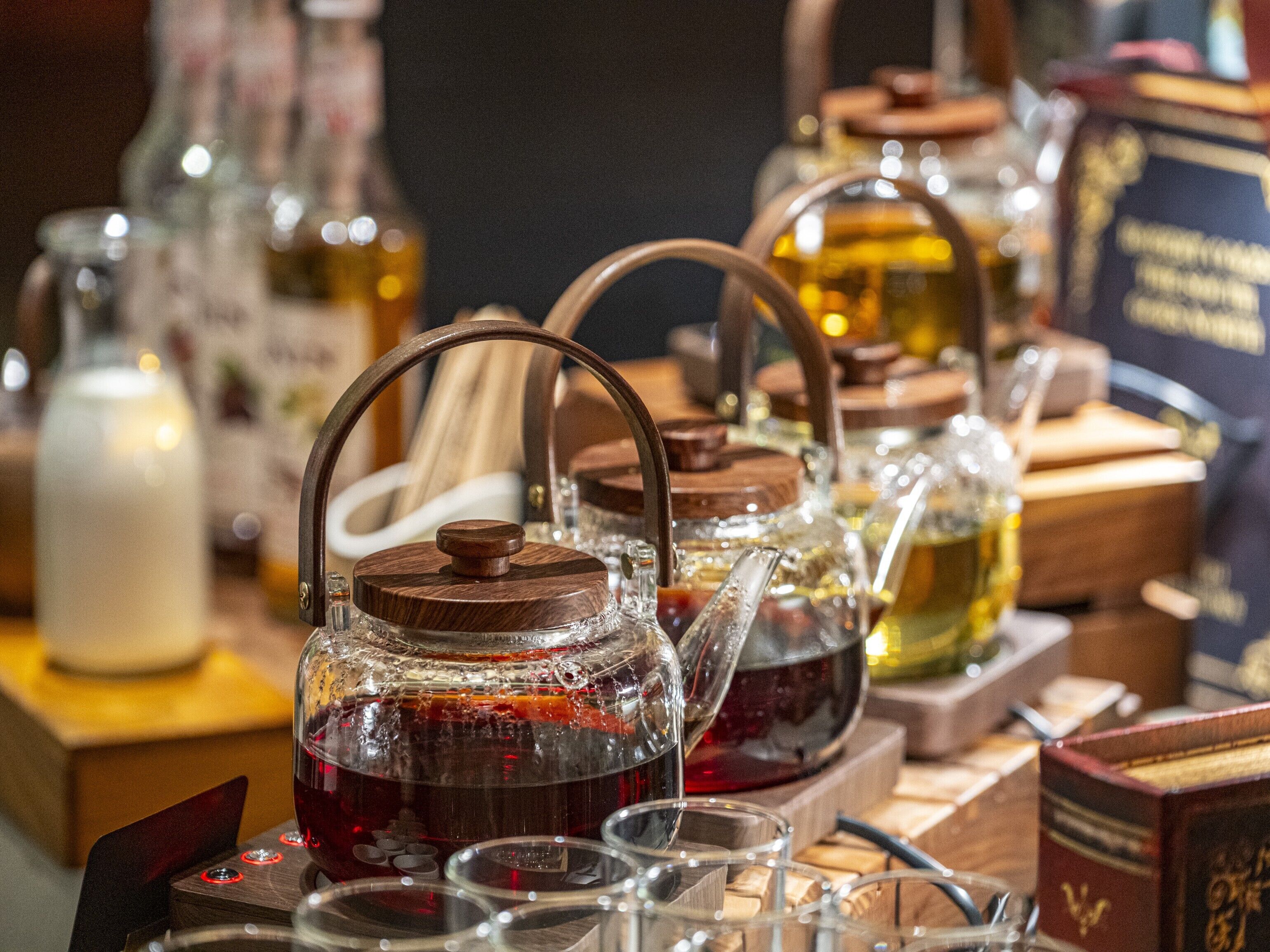A variety of glassware and wooden containers on a table, likely for serving beverages.