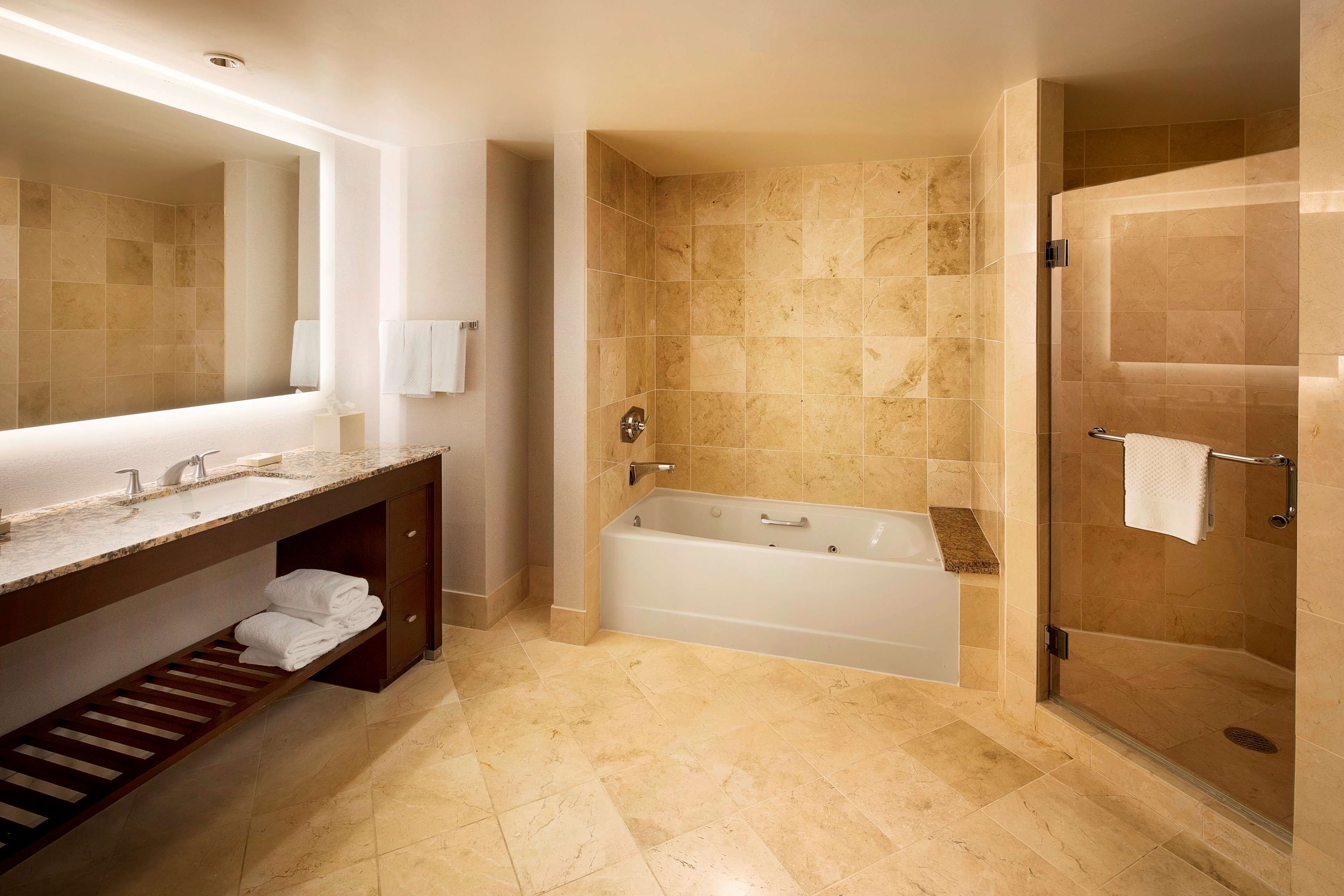 combined shower/bathtub, designer toiletries, hair dryer, bathrobes