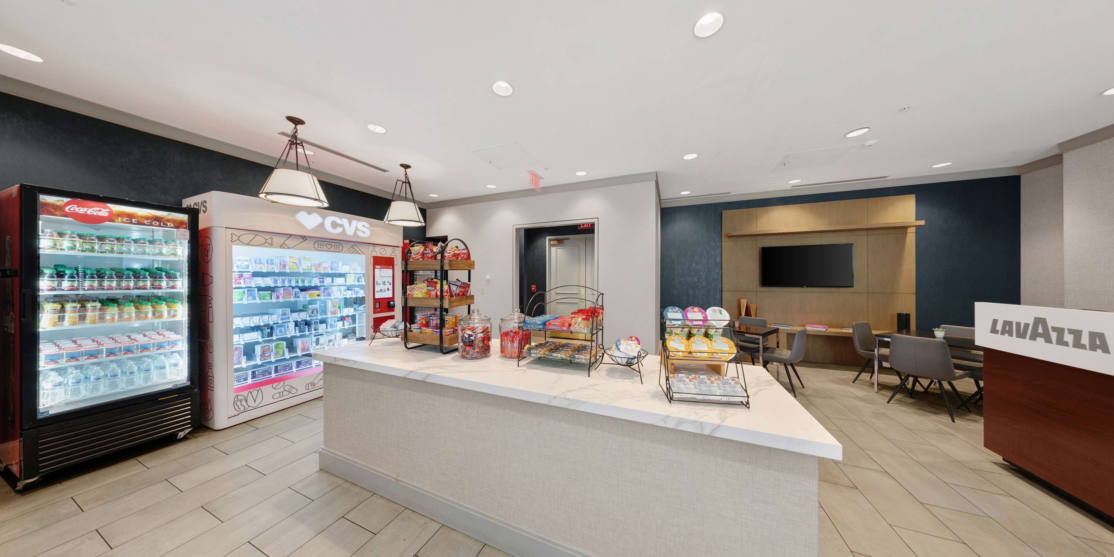 A reception area with a counter, vending machines, and a seating area.