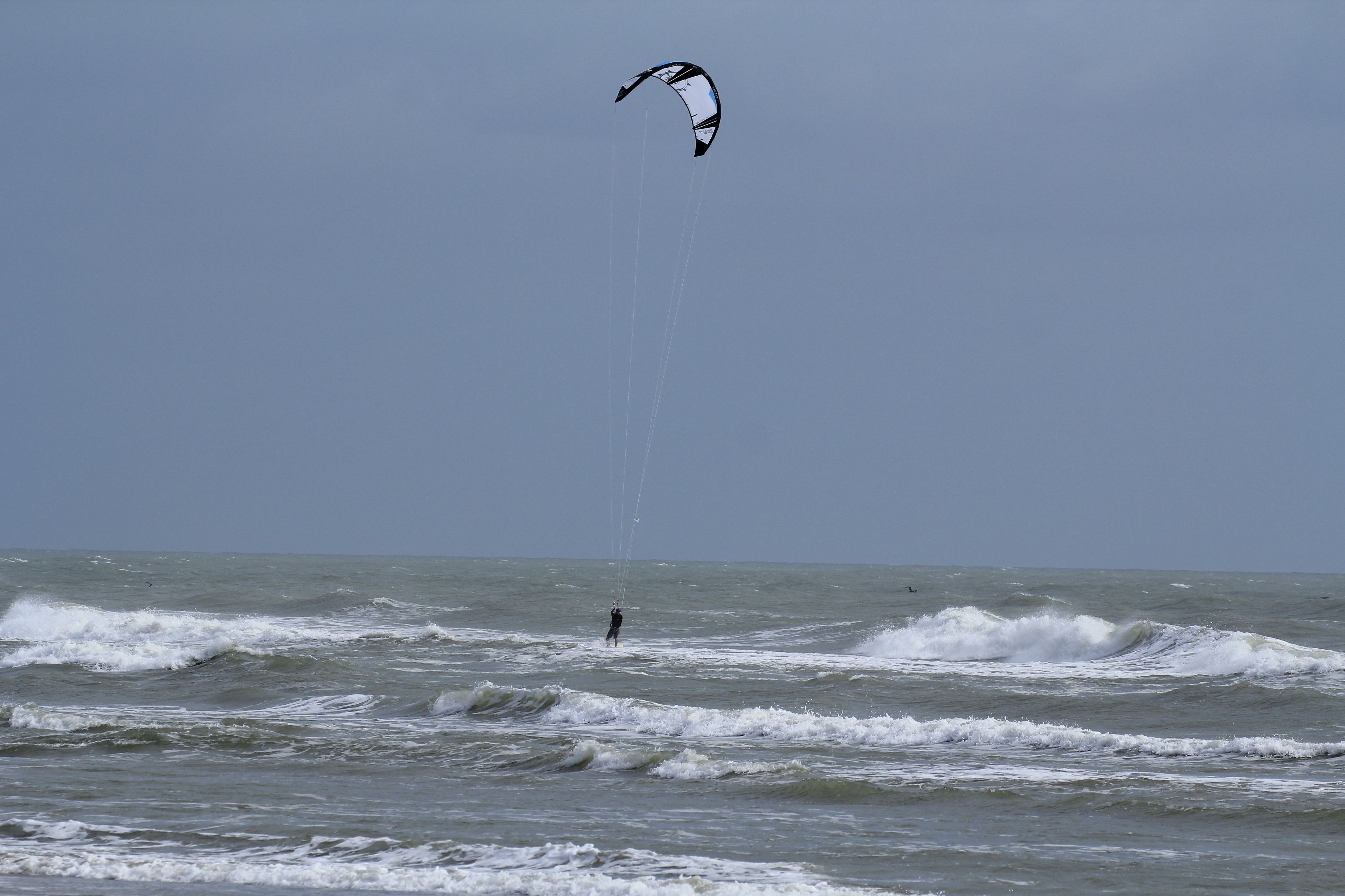 A person kite surfing in the ocean.