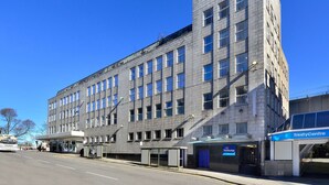 A multi-story building with a flat facade, large windows, and a visible entrance to a travel agency. - Travelodge Aberdeen Central (Aberdeen)