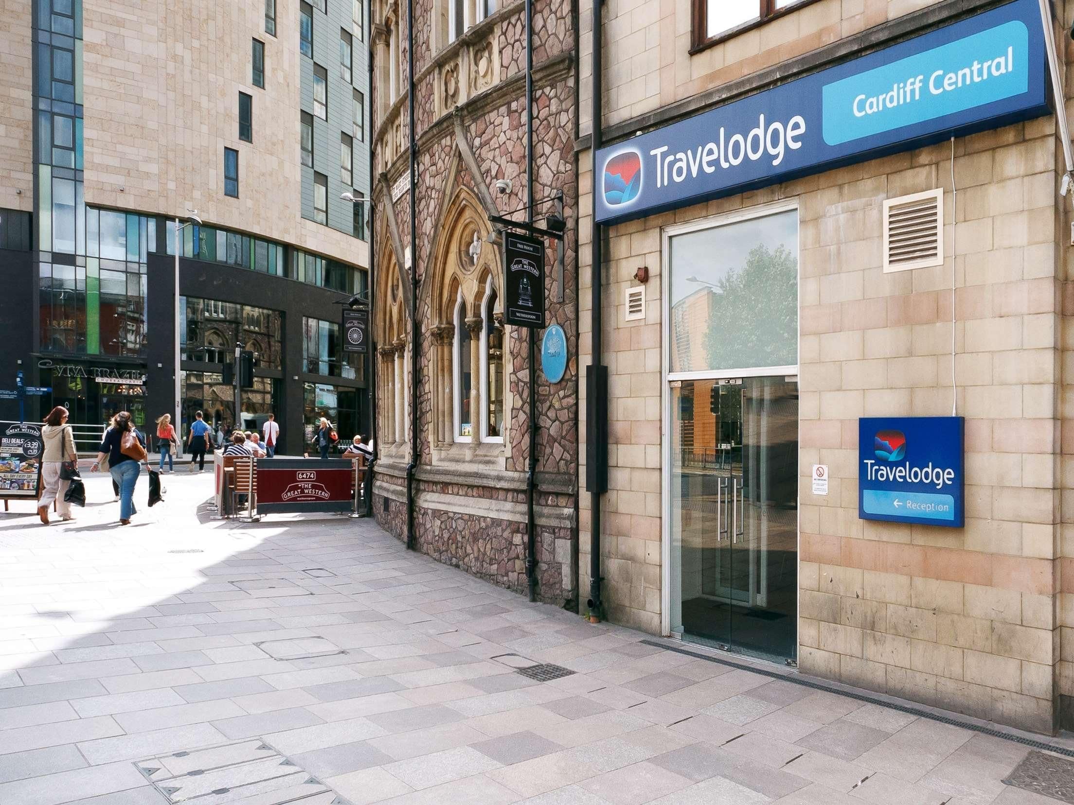 A Travelodge hotel with a stone facade and large windows.