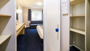 A hotel room with a bed, a desk, a chair, a window, and a bathroom. - OYO Sunrise Hotel, A46 N Leicester (Leicester)
