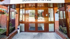 The entrance to Sunrise Hotel with a prominent 'OYO' sign above the doors. - OYO Sunrise Hotel, A46 N Leicester (Leicester)