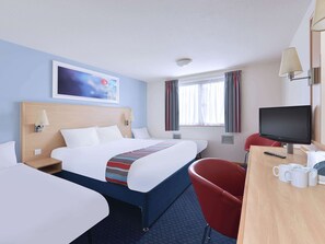 A hotel room with a large bed, a desk with a TV, and a red chair. - Travelodge Stirling M80 (Stirling)