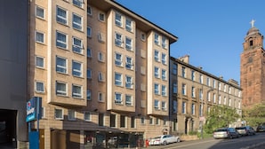 A multi-story hotel with a prominent tower, large windows, and a visible entrance. - Travelodge Glasgow Central (Glasgow)
