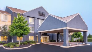 A modern hotel with a covered entrance, a landscaped front yard, and a sign indicating it is a Fairfield Inn & Suites. - Fairfield Inn By Marriott Indianapolis Northwest (Indianapolis)