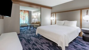 A hotel room with a large bed, a small table, a sofa, and a TV. - Fairfield Inn By Marriott Indianapolis Northwest (Indianapolis)
