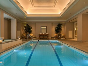 Relax by the pool surrounded by comfortable lounge chairs and a serene atmosphere.