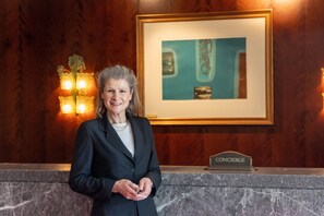 A reception desk with a marble top, a framed artwork above it, and a sign that reads "CONCIERGE". - InterContinental Dublin by IHG (Dublin)