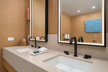 Gaslamp Quarter Loft Suite - 1 King | Bathroom | Designer toiletries, hair dryer, bathrobes, towels at Hilton San Diego Gaslamp Quarter