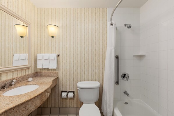 A bathroom with a sink, toilet, and shower. - Hilton Garden Inn Milwaukee Northwest Conference Center (Milwaukee)