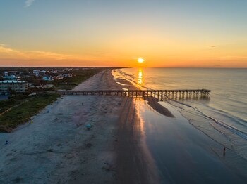 Stroll along the pier and enjoy the serene ocean views. at The Palms Oceanfront Hotel