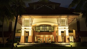 A hotel with a symmetrical facade, large glass windows, and a central entrance with a canopy. - Holiday Inn Resort Batam by IHG (Batam)