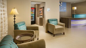A hotel lobby with seating areas, a reception desk, and a minibar. - Holiday Inn Express & Suites DFW - Grapevine by IHG (Grapevine)