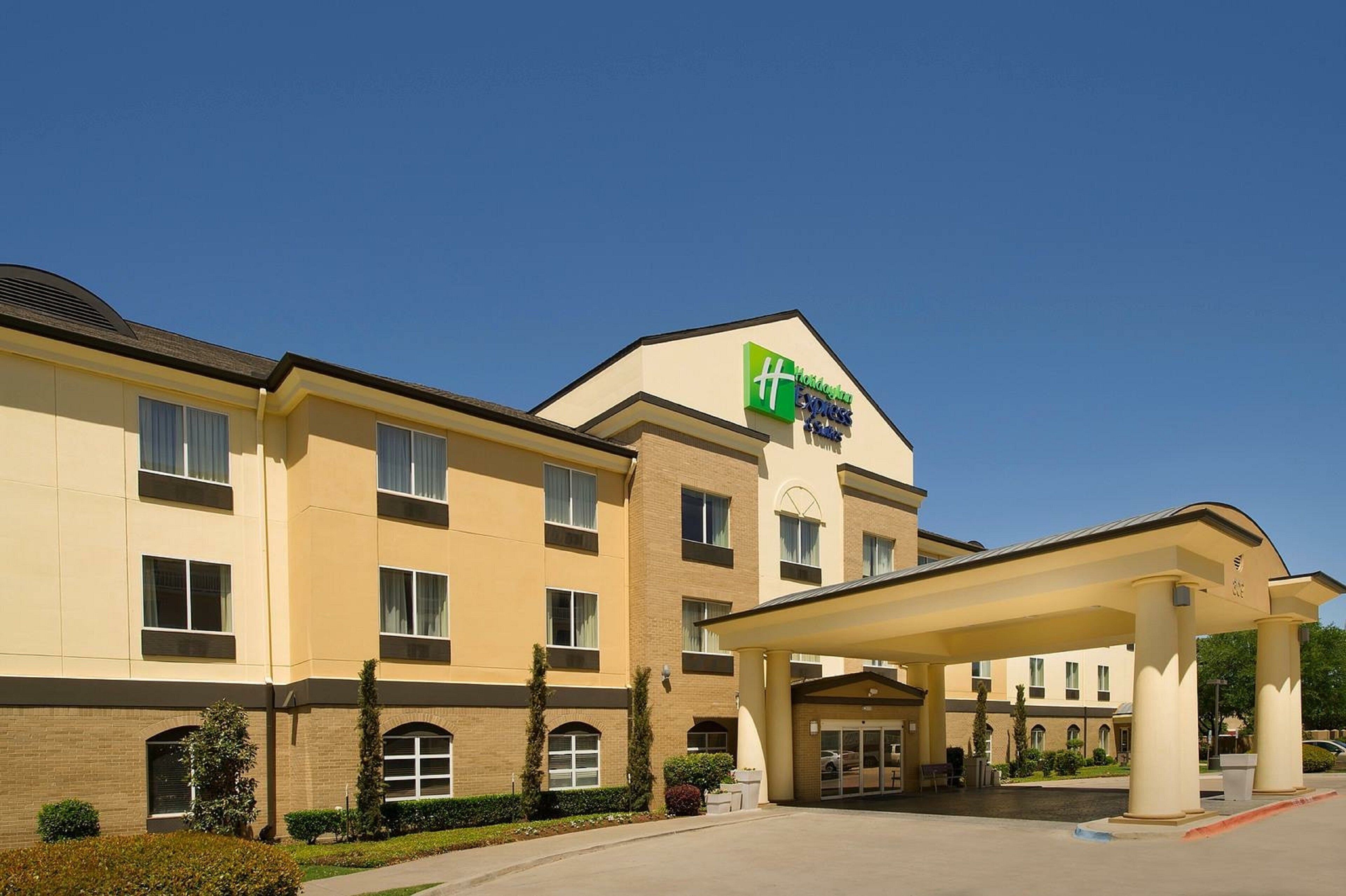 A Holiday Inn Express hotel with a covered entrance and a brick facade.