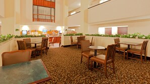 A hotel lobby with multiple seating areas, a reception desk, and a patterned carpet. - Holiday Inn Express & Suites Birmingham Trussville by IHG (Birmingham)