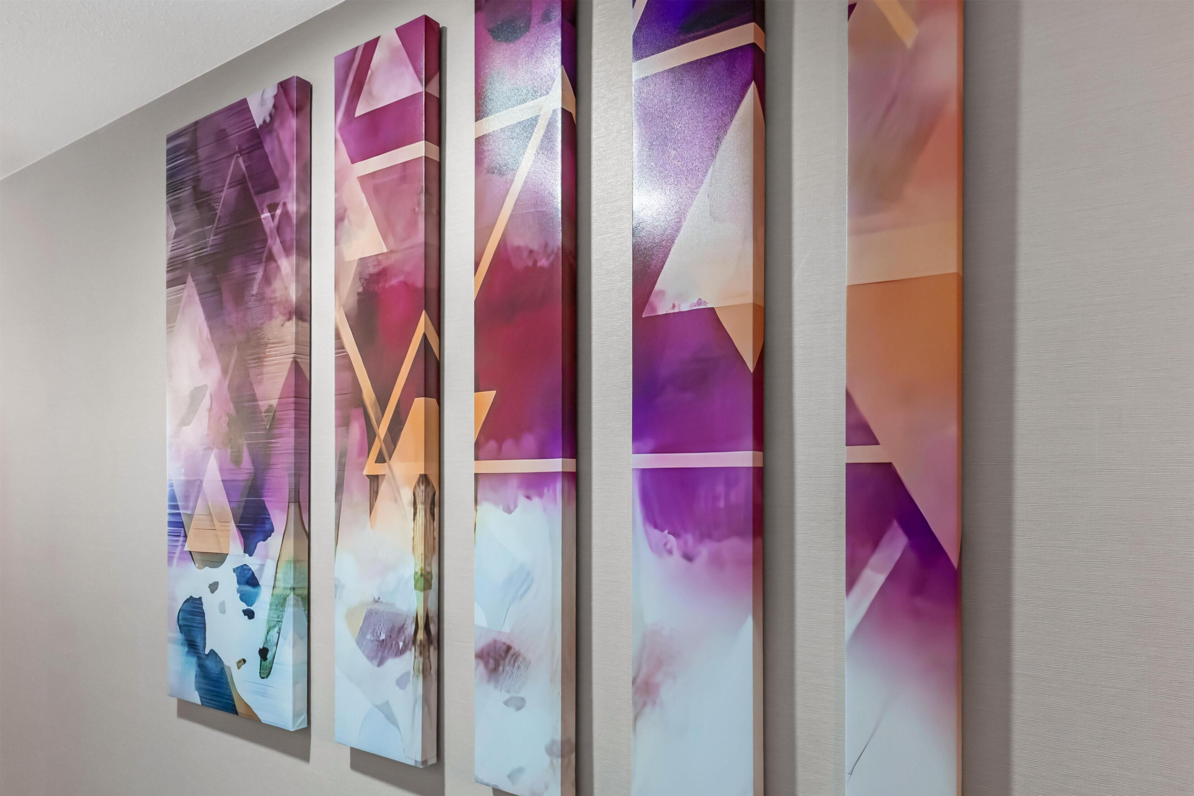 A wall with four vertical panels featuring abstract geometric patterns.