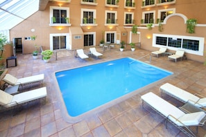 Indoor pool, open 8:00 AM to 8:00 PM, pool loungers