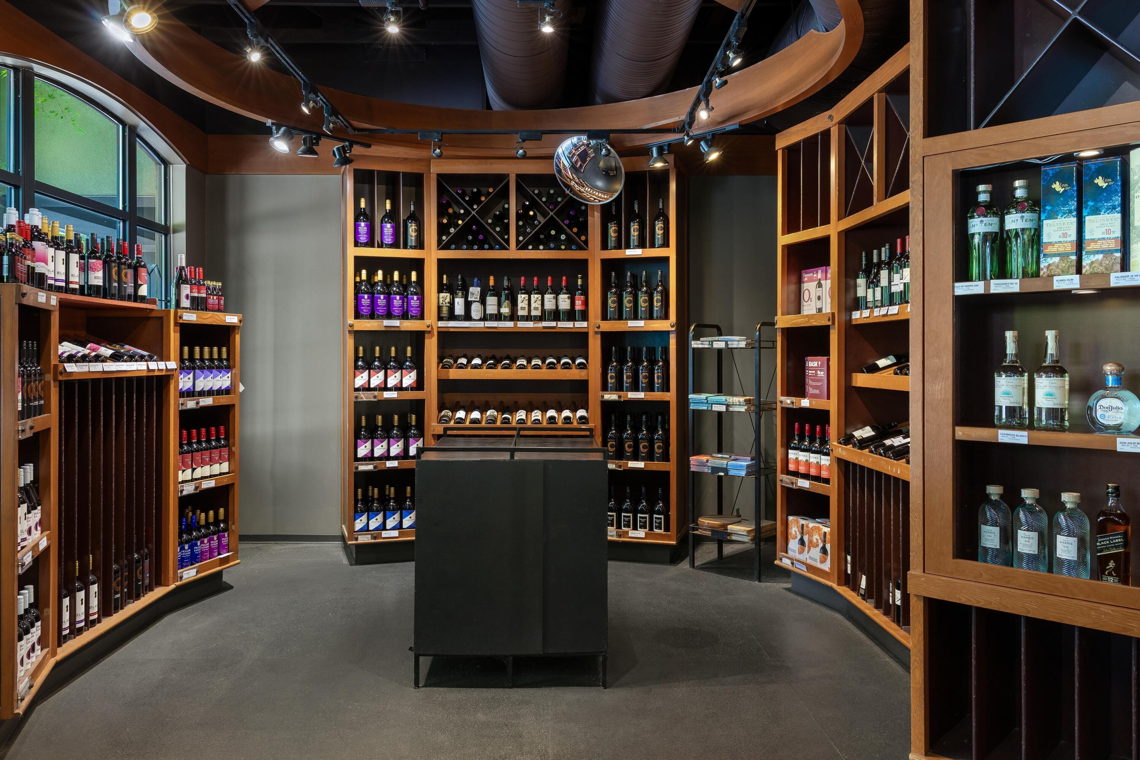 A wine cellar with wooden shelves and a central display case.