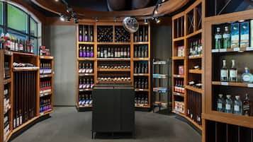 A wine cellar with wooden shelves and a central display case.
