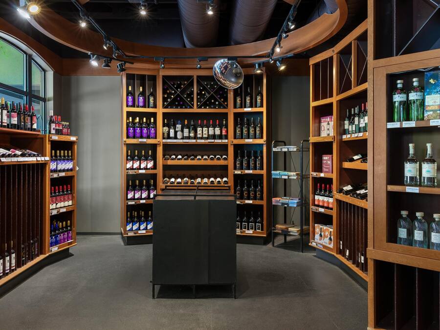 A wine cellar with wooden shelves and a central display case.