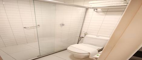 A modern bathroom with a glass-enclosed shower, a white toilet, and a towel rack.