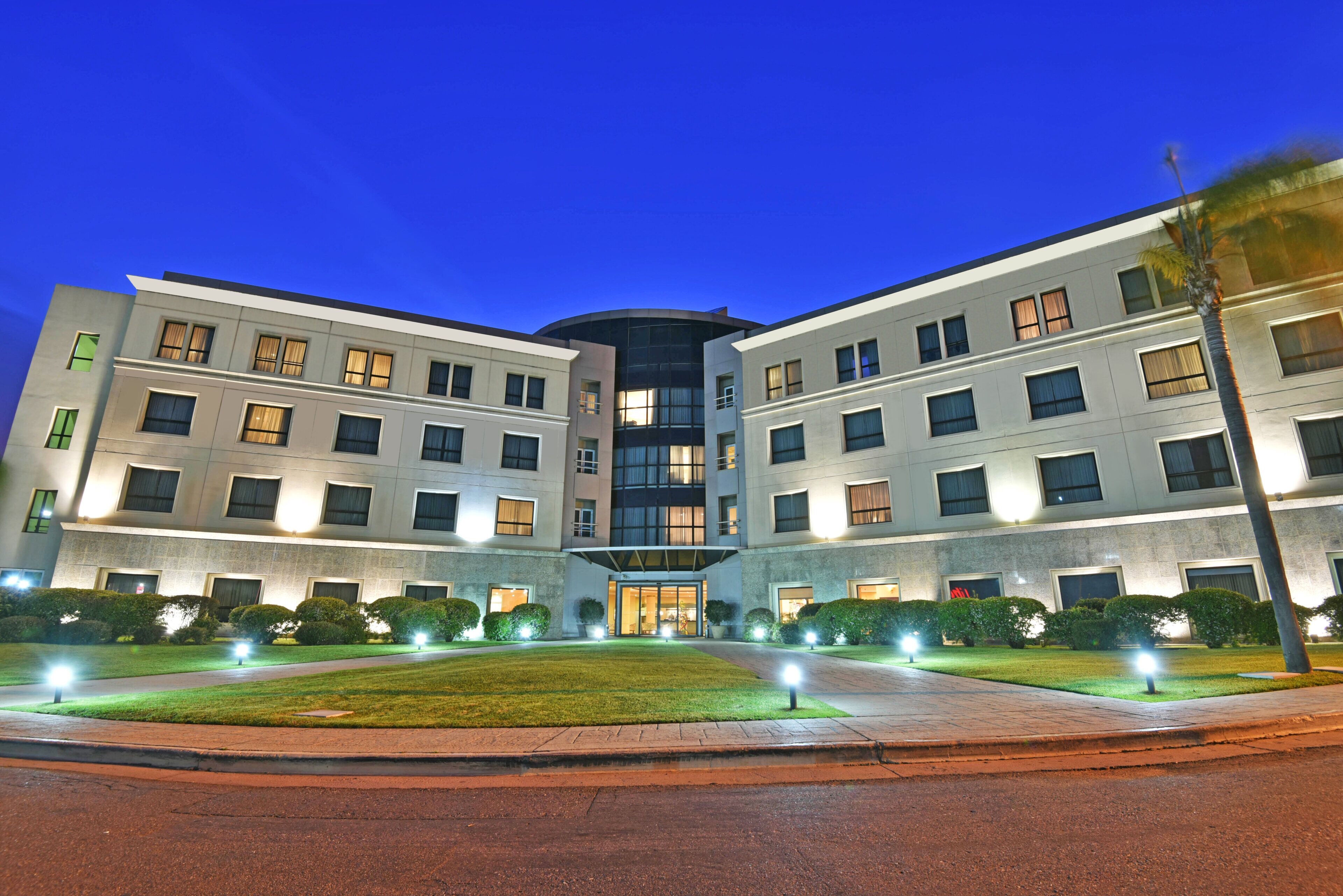 A modern building with a symmetrical facade, multiple windows, and a central entrance.