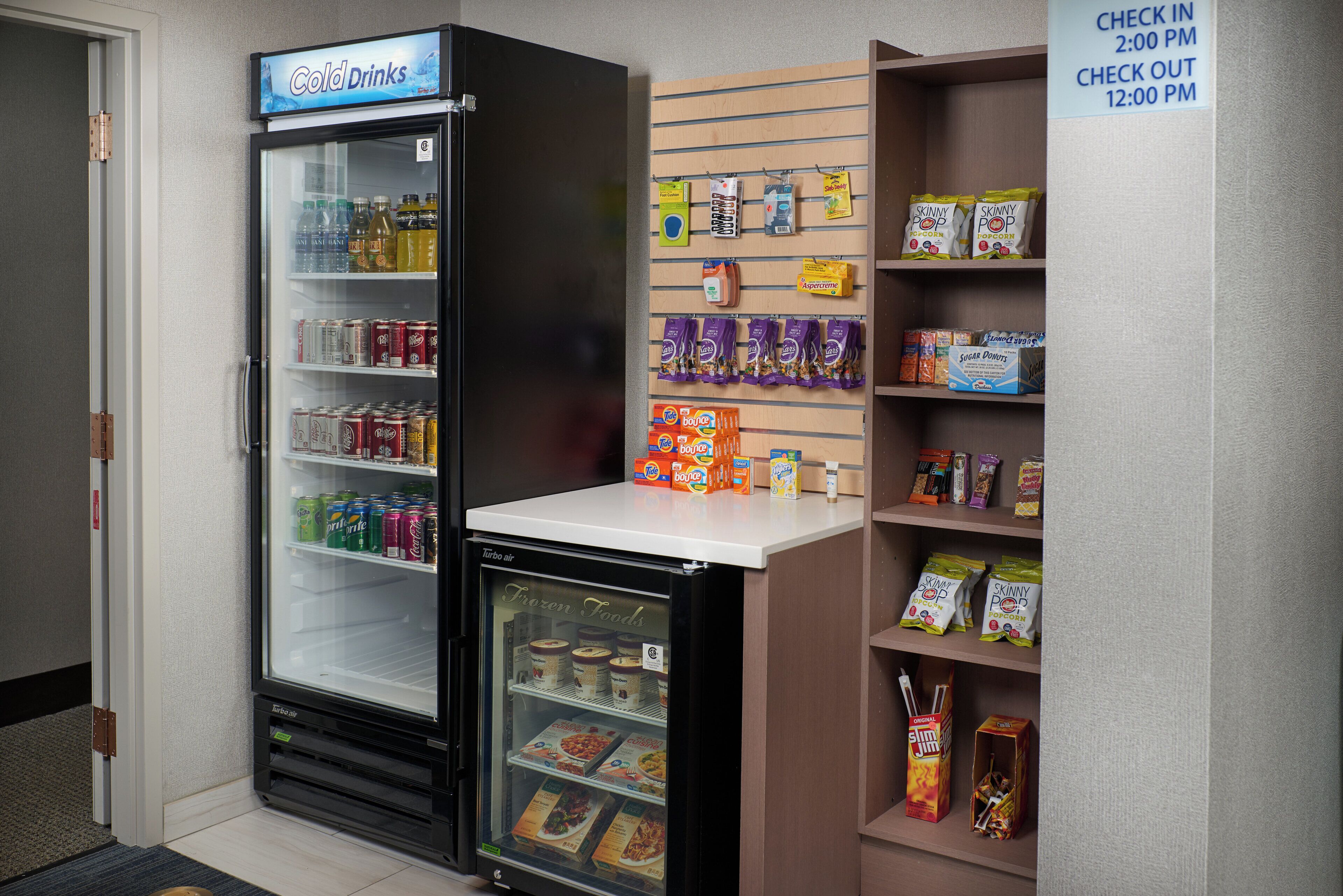 A vending machine with a variety of beverages and snacks, including a section for frozen foods.