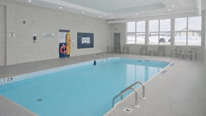 A swimming pool with a 1.2m depth, indoor seating area, and large windows. - Holiday Inn Express Dryden by IHG (Dryden)