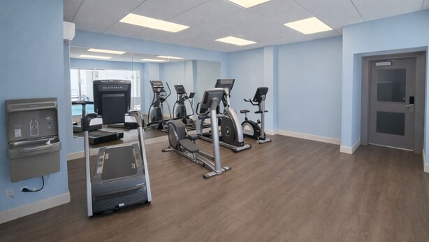 A fitness center with cardio machines, a water fountain, and a reception area. - Holiday Inn Express Dryden by IHG (Dryden)
