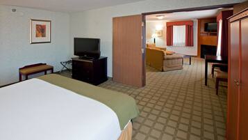 A hotel room with a bed, a television, a desk, and a chair.