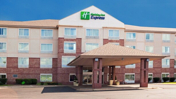 A Holiday Inn Express hotel with a brick facade, multiple windows, and a covered entrance.