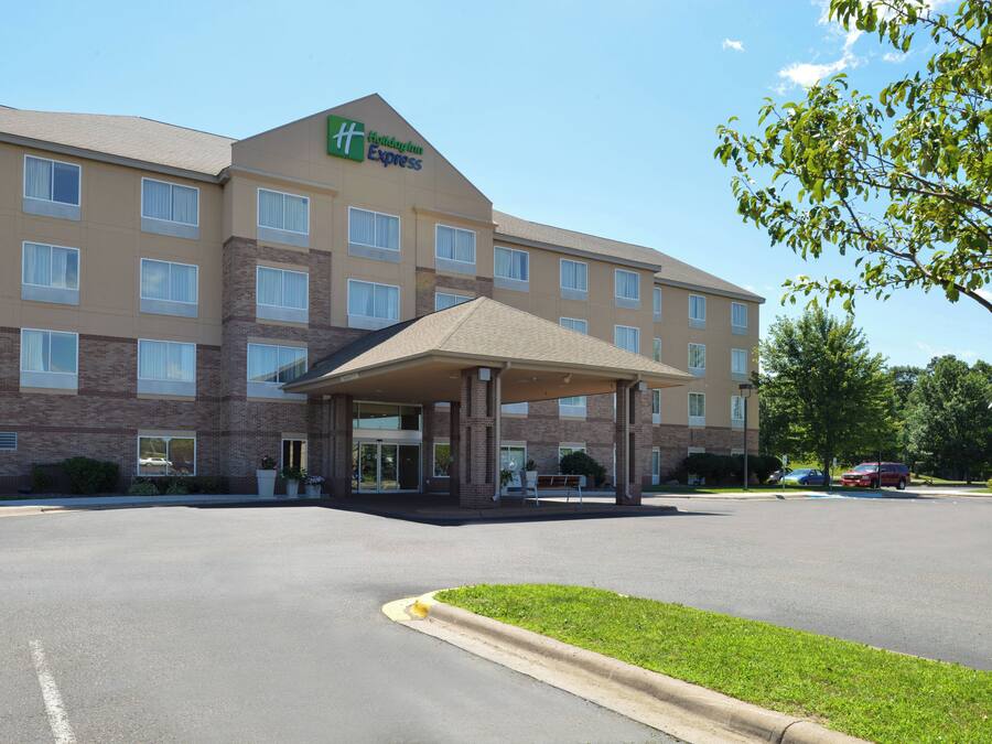 A Holiday Inn Express hotel with a covered entrance, multiple windows, and a parking lot.