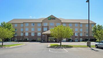 A Holiday Inn Express hotel with a central entrance, multiple floors, and a parking lot.
