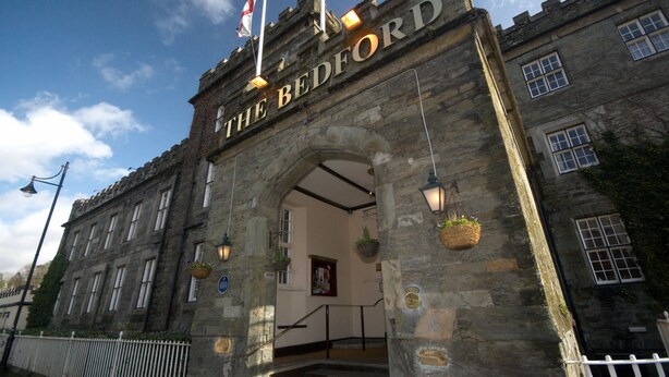 A historic building with a stone archway entrance labeled "The Bedford." - The Bedford Hotel (Tavistock)