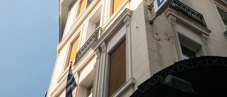 A hotel with a classic architectural style, featuring a prominent sign on the facade.