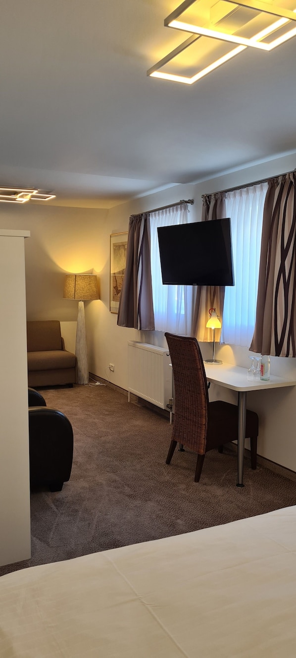 Comfort Double Room | Living area | 26-cm flat-screen TV with cable channels, TV