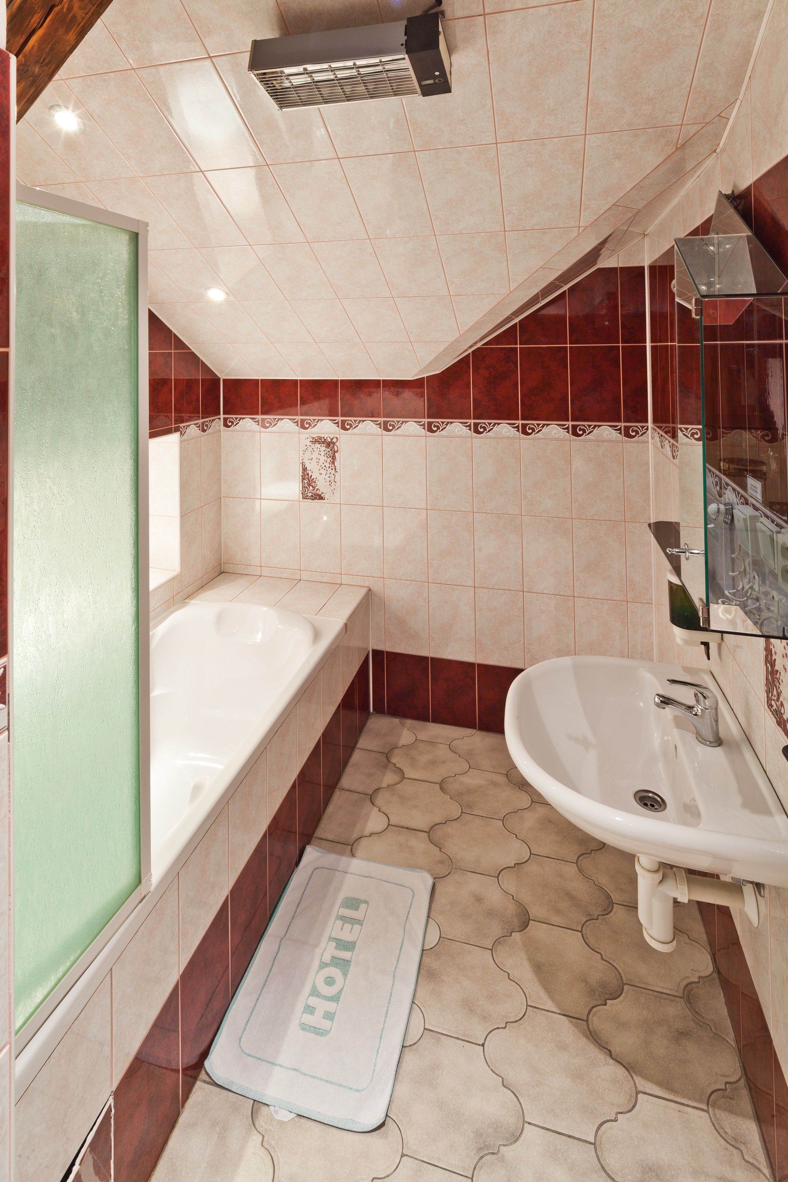 A bathroom with a bathtub, sink, and a shower.