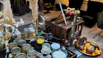 A buffet setup with various food items and condiments.